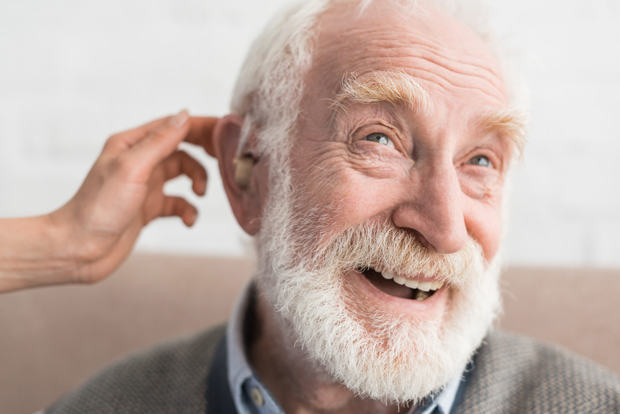 Woman,Hand,Helping,Grey,Haired,Man,,Wearing,Hearing,Aid