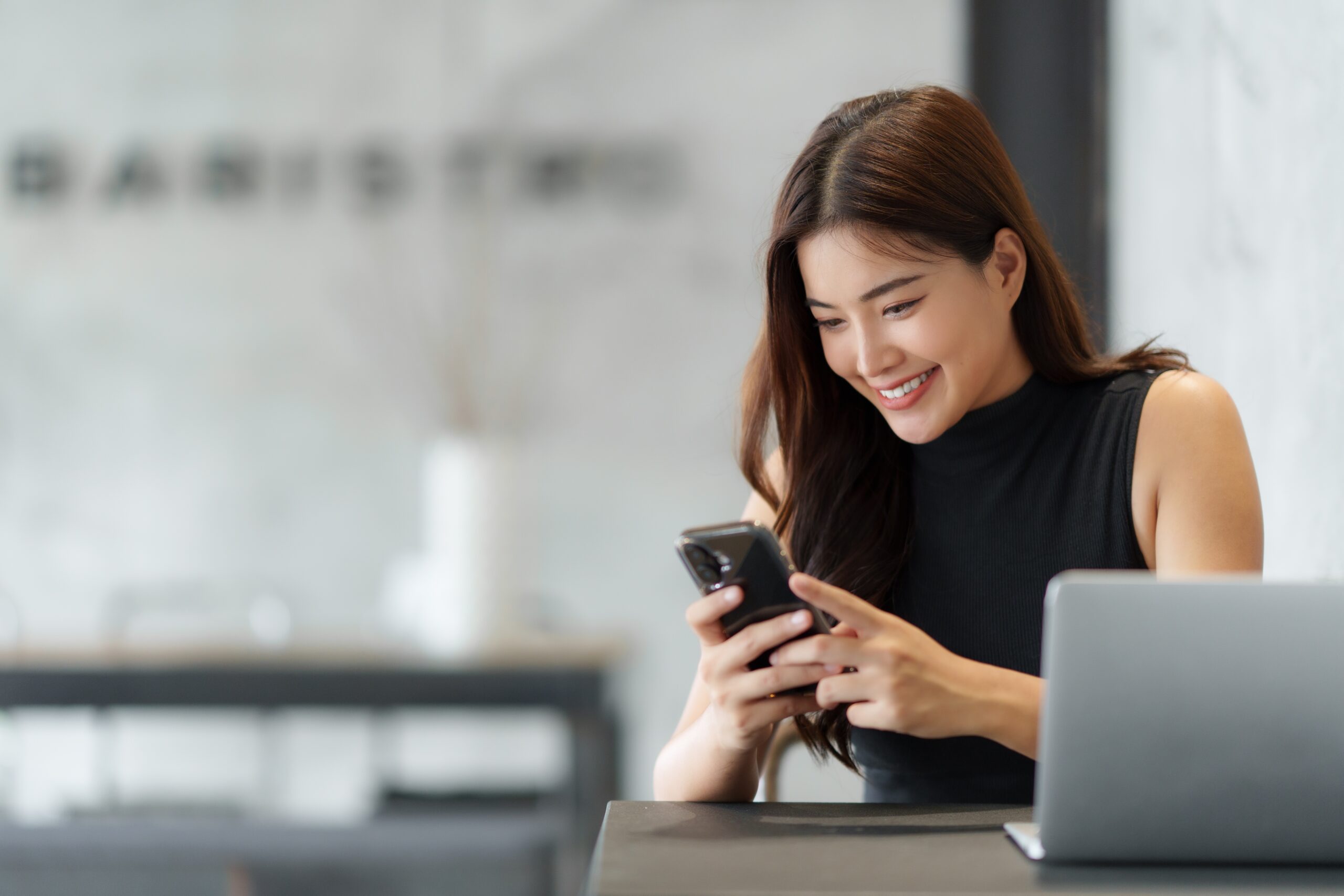 Happy,Entrepreneur,Reading,Good,News,On,Her,Smartphone,And,Smiling