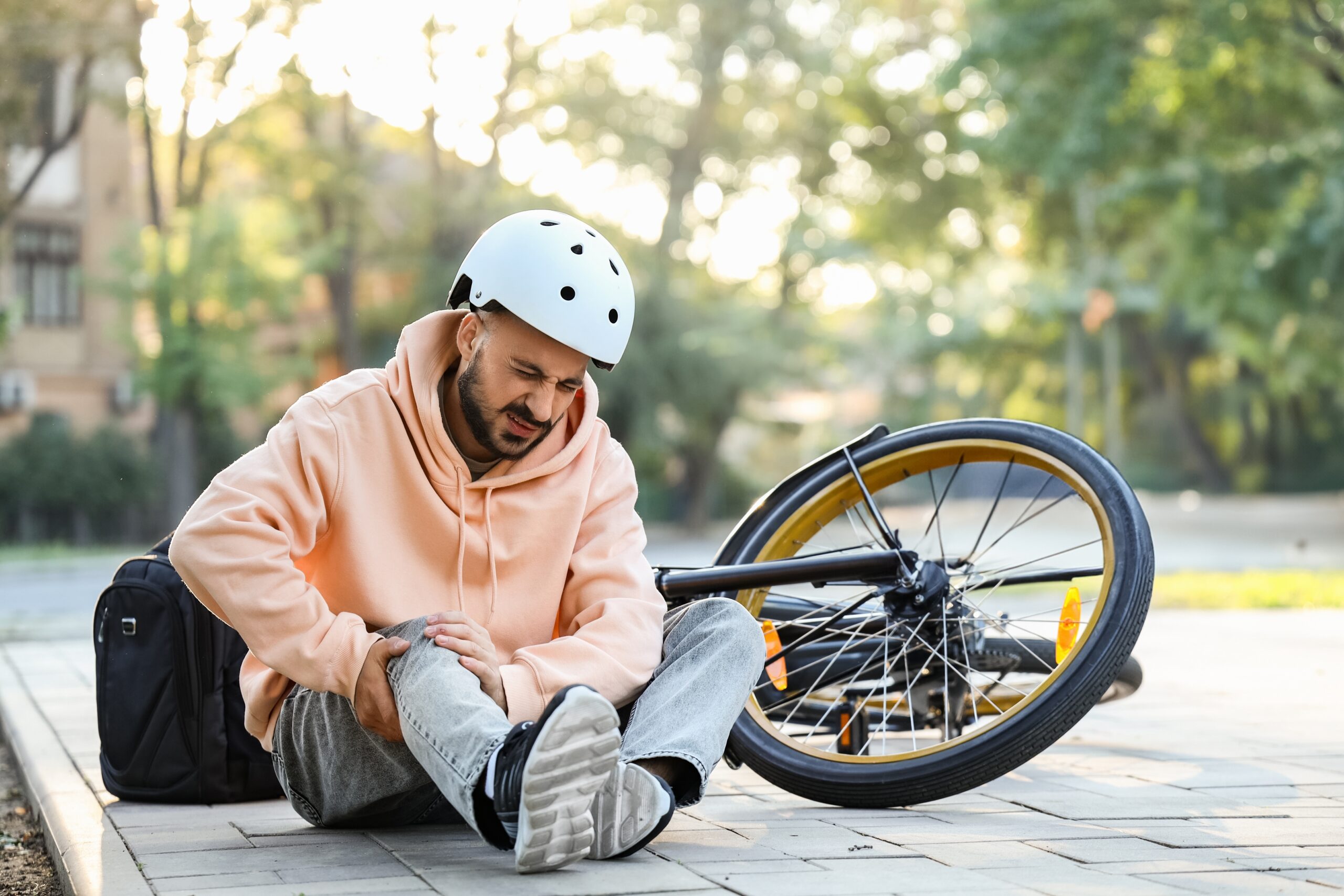 Young,Man,With,Injured,Leg,After,Falling,Off,His,Bike